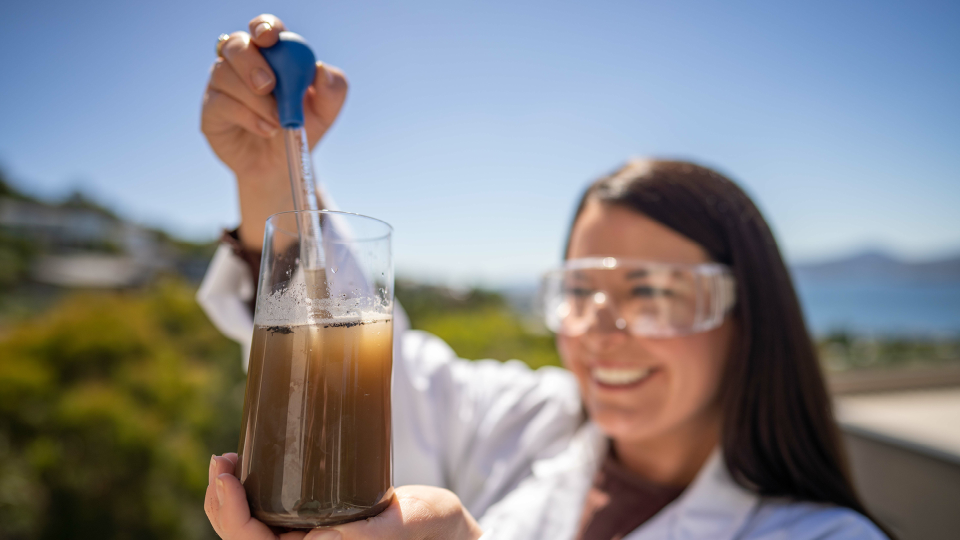 Female scientist testing microbial content in soil